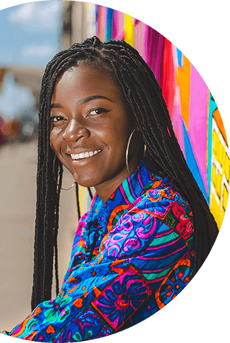 woman with colourful shirt against colourful wall art